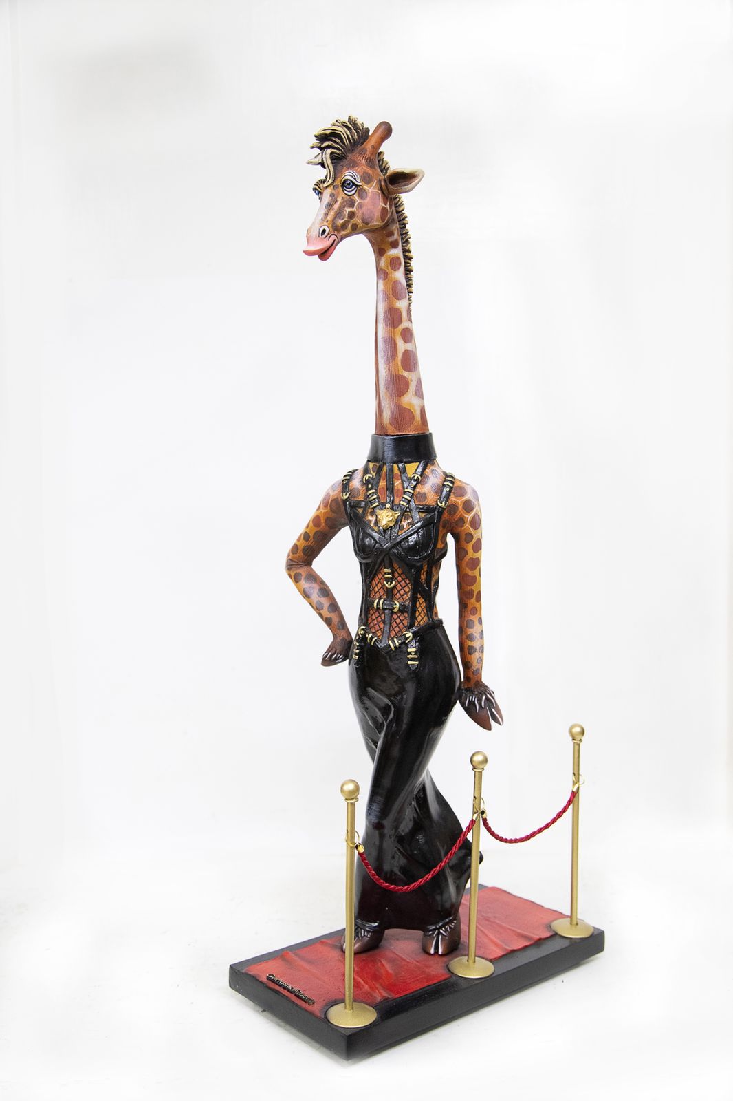 Signed, limited edition giraffe on red carpet sculpture