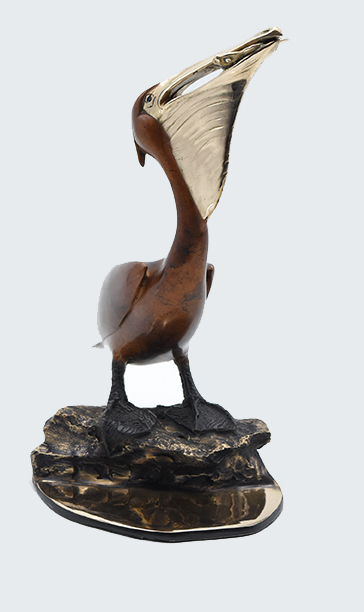 Signed, limited edition bronze pelican with fish sculpture